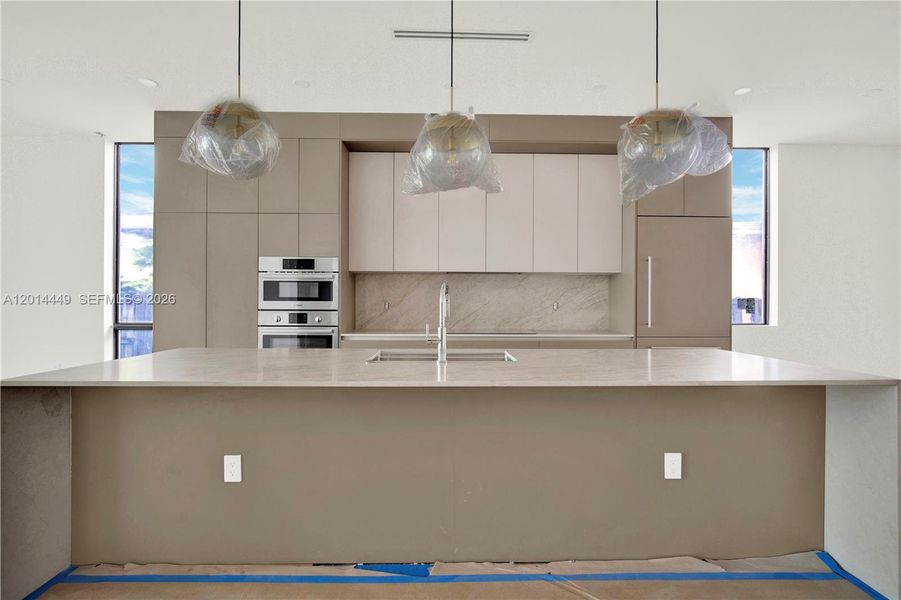 Room for 5-6 stools with elegant light fixtures.