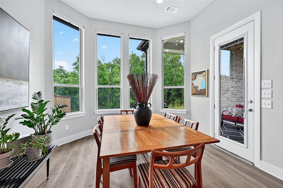 Dining area featuring plenty of natural light and light wood-type flooring Dining area featuring plenty of natural light and light wood-type flooring