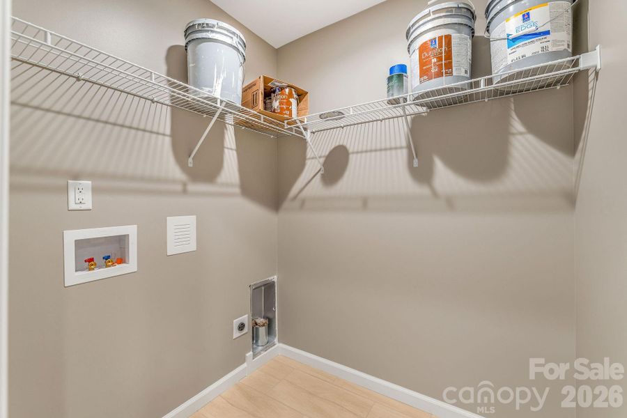 designated laundry room with storage