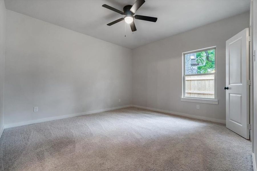 Unfurnished room featuring ceiling fan and light colored carpet