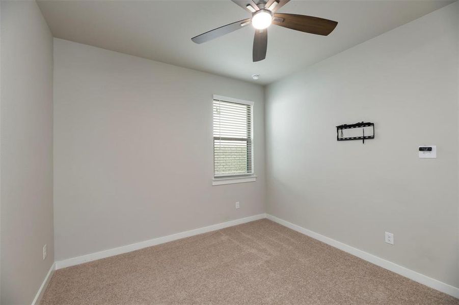 Spare room with light colored carpet and ceiling fan Spare room with light colored carpet and ceiling fan