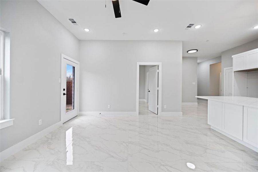 Spare room featuring recessed lighting, visible vents, marble finish floor, and baseboards