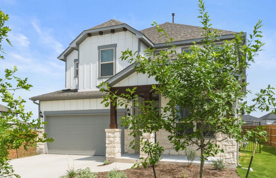 Front exterior of a new home in Santa Rita Ranch, Liberty Hill, TX, highlighting curb appeal (Image 22). Front exterior of a new home in Santa Rita Ranch, Liberty Hill, TX, highlighting curb appeal (Image 22).