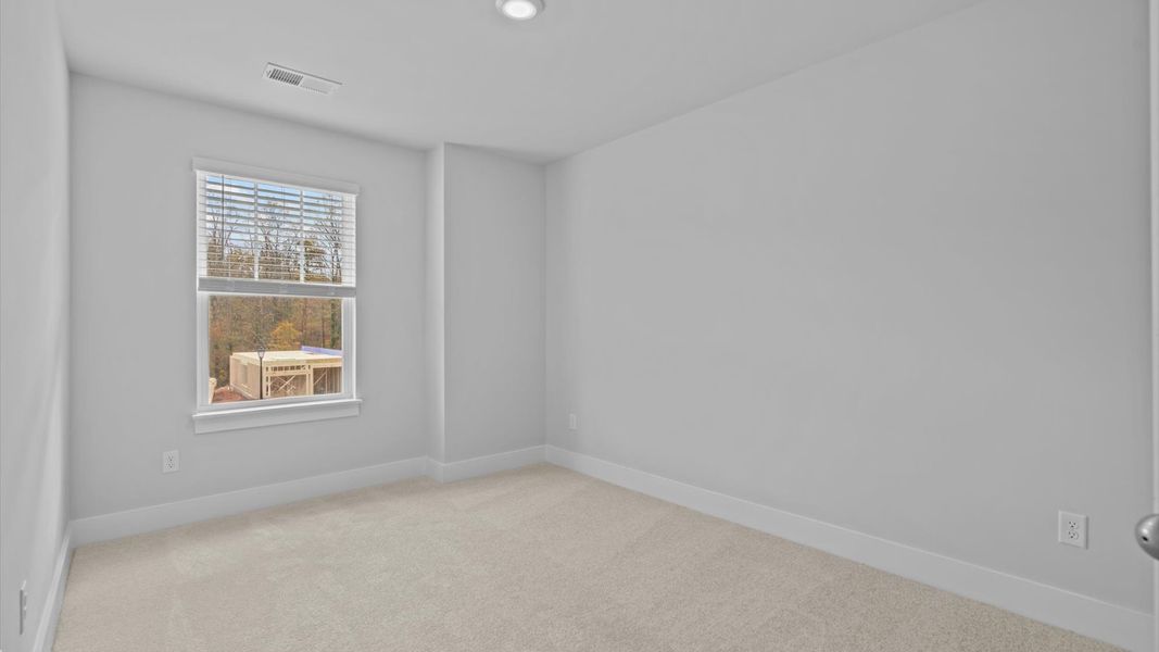Accomplished design in this restful bedroom featuring plush carpet and oversized window views Accomplished design in this restful bedroom featuring plush carpet and oversized window views