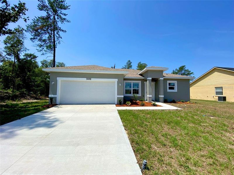 Front exterior of a new home in , Ocala, FL, highlighting curb appeal (Image 1).