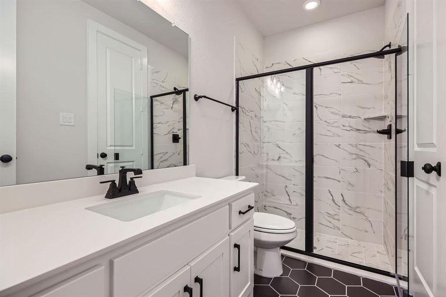 Full bath with toilet, vanity, a marble finish shower, recessed lighting, and tile patterned floors Full bath with toilet, vanity, a marble finish shower, recessed lighting, and tile patterned floors