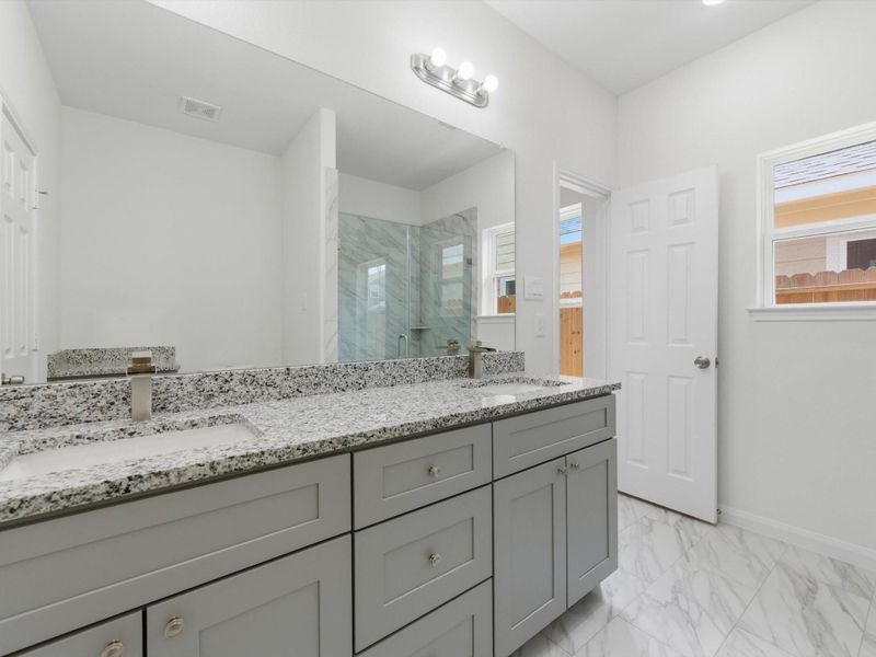 Start and end your day in a beautifully designed en-suite featuring dual sinks, a glass shower, and spacious walk-in closet. Start and end your day in a beautifully designed en-suite featuring dual sinks, a glass shower, and spacious walk-in closet.