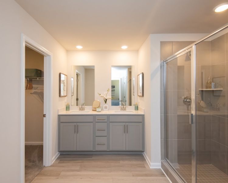 Dual vanities in the primary suite offer style and convenience for two. Dual vanities in the primary suite offer style and convenience for two.