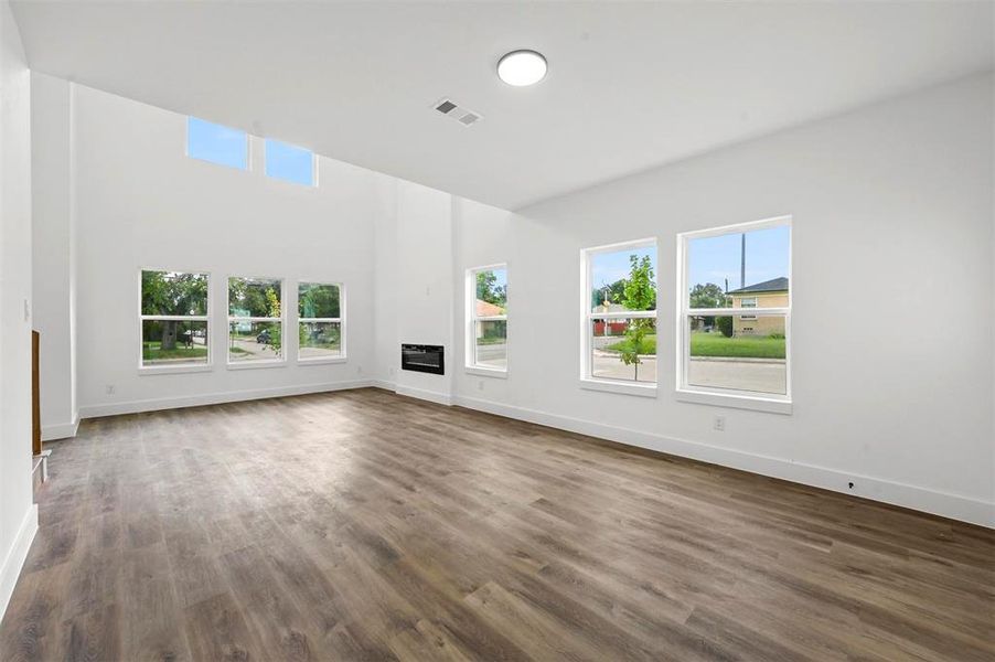 Unfurnished living room featuring wood-type flooring