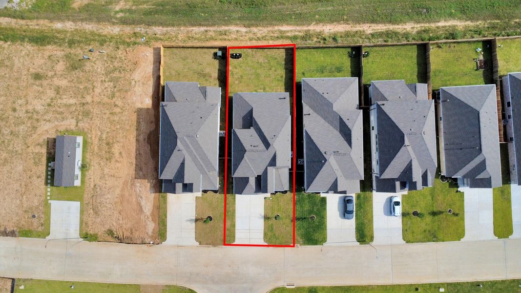 An aerial view of a spacious subdivision lot, highlighting a well-maintained yard and a fully fenced perimeter, offering both privacy and expansive outdoor space. An aerial view of a spacious subdivision lot, highlighting a well-maintained yard and a fully fenced perimeter, offering both privacy and expansive outdoor space.