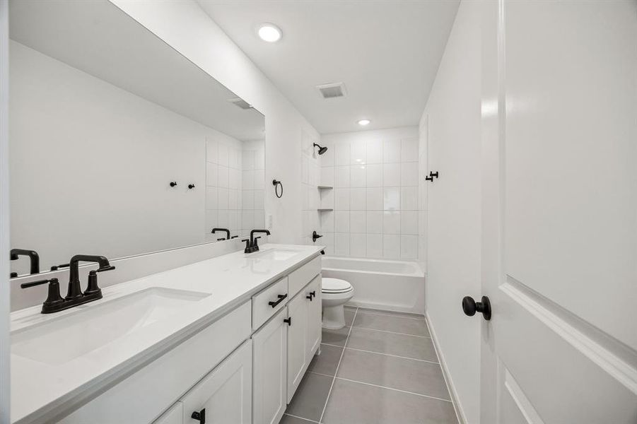 Guests will enjoy their own vanity space in this thoughtfully designed guest bath.