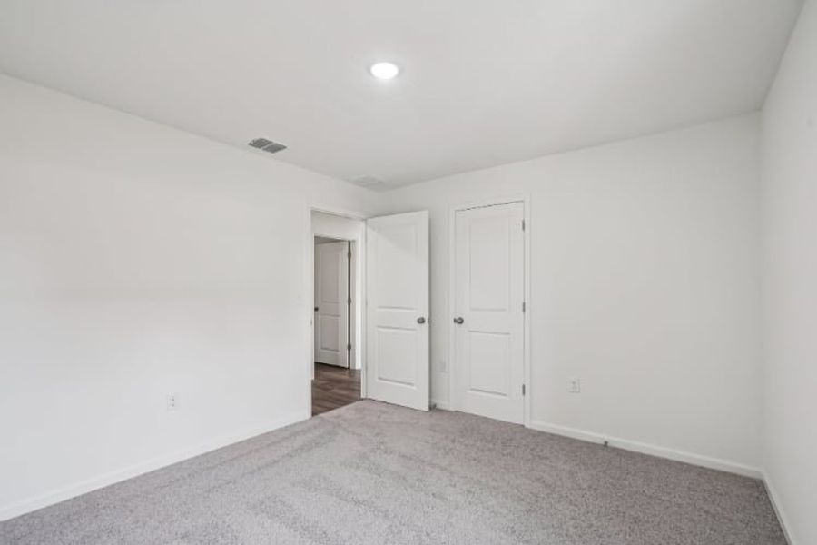 A hallway with white doors.