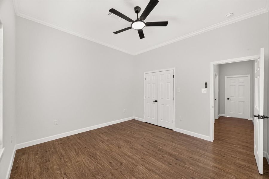 Spacious secondary bedroom with natural light and no carpet.
