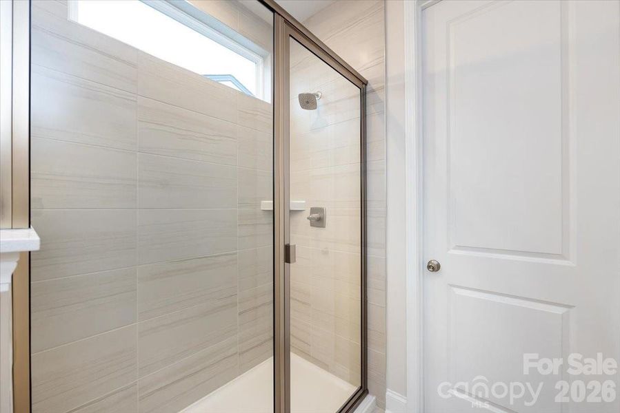 Primary Walk-In Shower with Tiled Walls