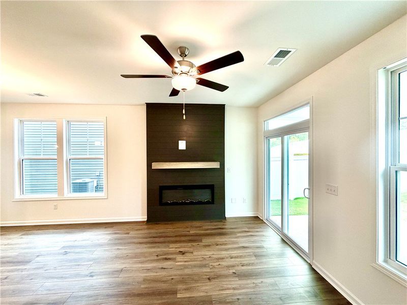 A modern fireplace anchors the open living space,
