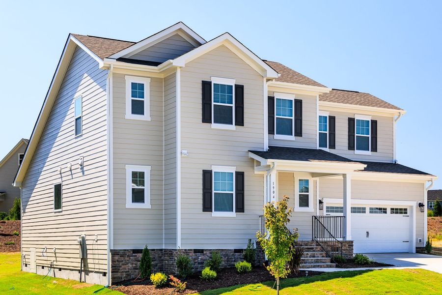 Front exterior of a new home in High Grove Oaks, Fuquay Varina, NC, highlighting curb appeal (Image 2). Front exterior of a new home in High Grove Oaks, Fuquay Varina, NC, highlighting curb appeal (Image 2).