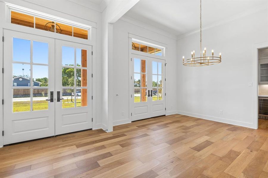 Entryway with a wealth of natural light, and light hardwood / wood-style flooring