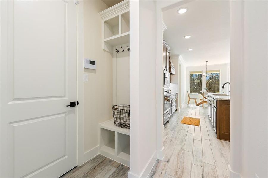 Mudroom with light wood-style floors and recessed lighting