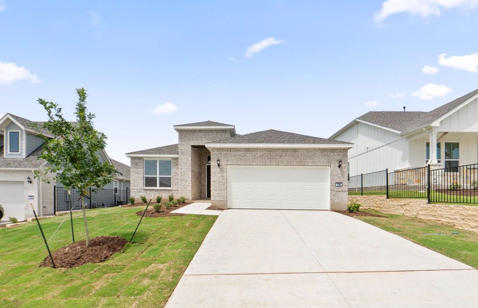 Front exterior of a new home in Sun City Texas, Georgetown, TX, highlighting curb appeal (Image 20).