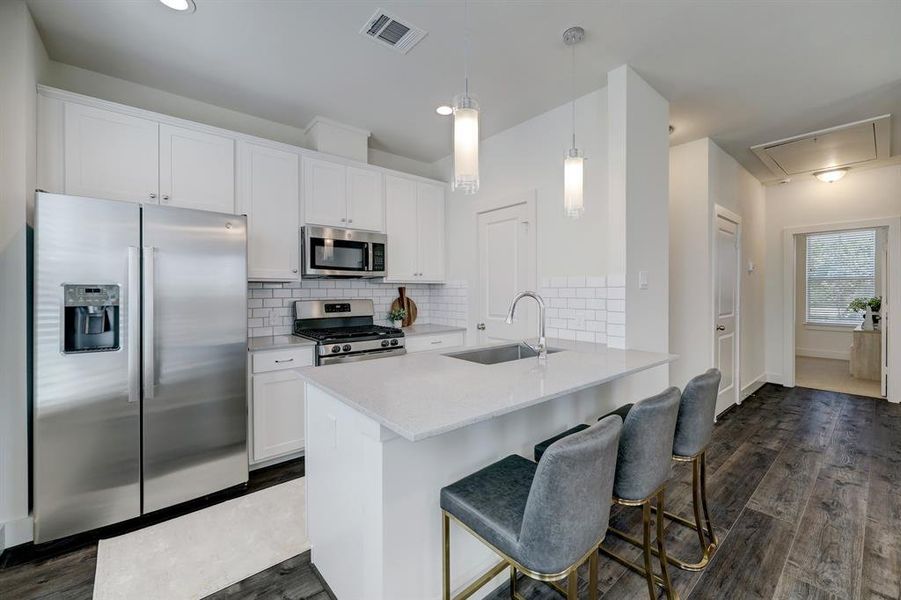 The thoughtfully designed kitchen boasts sleek countertops, ample storage space, and stainless appliances.