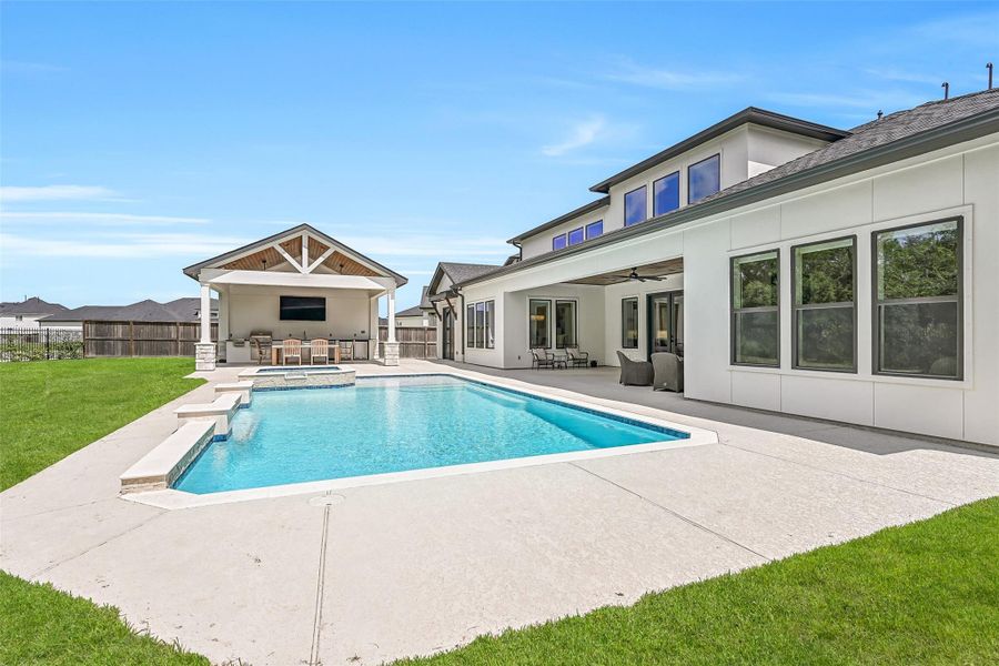 The backyard brings it all together with an Aqua Sport pool & raised spa, expansive covered patio and separate outdoor kitchen pavilion, creating multiple spaces for relaxing, dining & entertaining with plenty of lawn remaining.