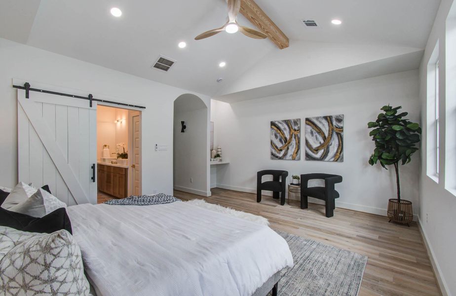 The spacious primary bedroom includes a sitting area and convenient coffee nook with room for a beverage fridge below. Nook may also be a personalized make-up area or computer station.