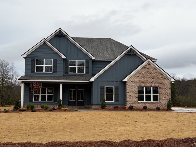 Front exterior of a new home in Blackwelder Bluff, Bowdon, GA, highlighting curb appeal (Image 1).
