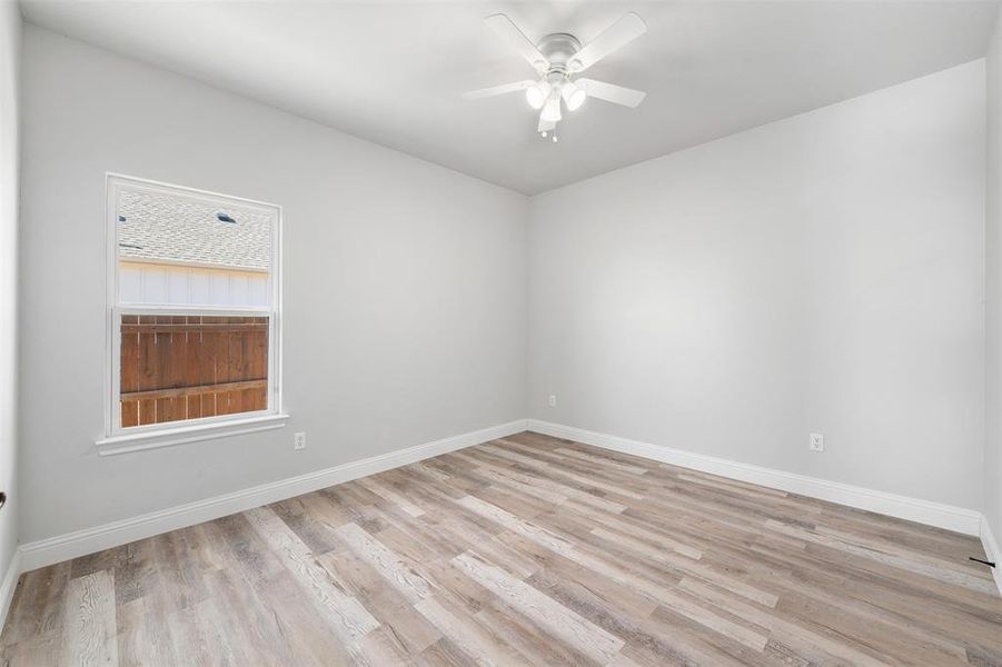 Empty room featuring ceiling fan and light wood-type flooring