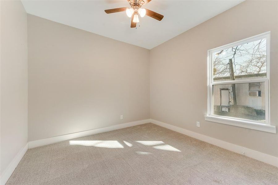 Unfurnished room with ceiling fan and carpet floors