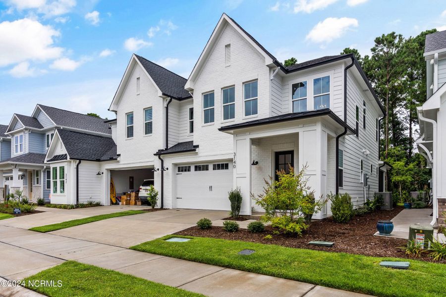Front exterior of a new home in East & Mason, Wilmington, NC, highlighting curb appeal (Image 2). Front exterior of a new home in East & Mason, Wilmington, NC, highlighting curb appeal (Image 2).