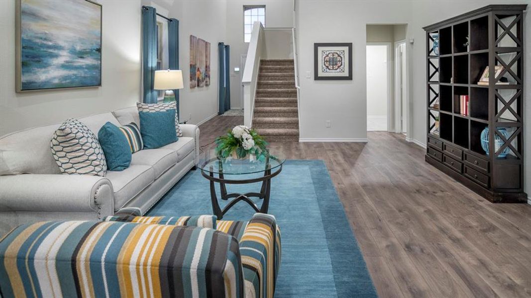 Living room featuring dark wood-style flooring and a high ceiling