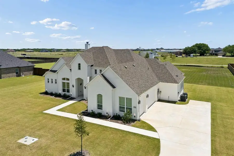 Front exterior of a new home in Springside Estates, Waxahachie, TX, highlighting curb appeal (Image 2). Front exterior of a new home in Springside Estates, Waxahachie, TX, highlighting curb appeal (Image 2).