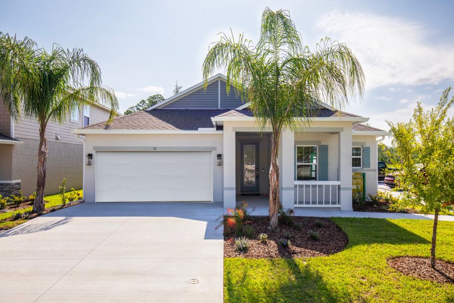 Front exterior of a new home in Enclave At Seminole Palms, Palm Coast, FL, highlighting curb appeal (Image 20).