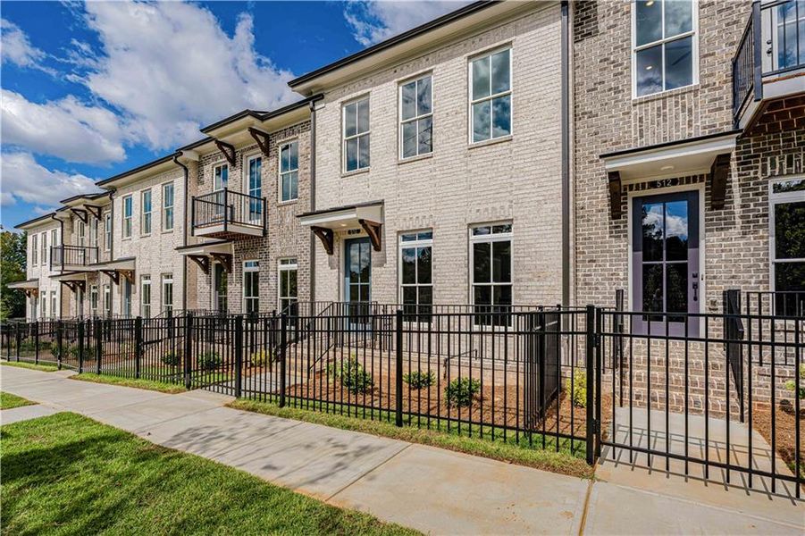 Exterior details and patio area of a home in Ward's Crossing Townhomes, Johns Creek (Image 4).