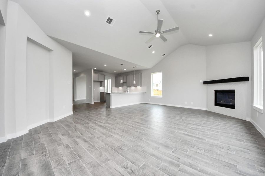 Embrace the warmth and comfort of this inviting family room, flooded with natural light! Sample photo of completed home with similar floor plan. Actual colors and selections may vary.