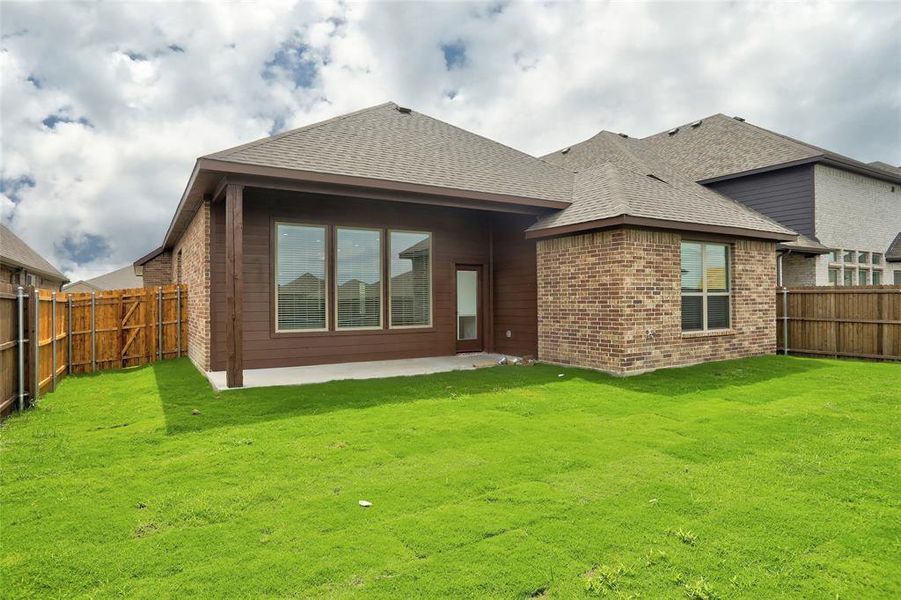 Back of house featuring a patio and a yard