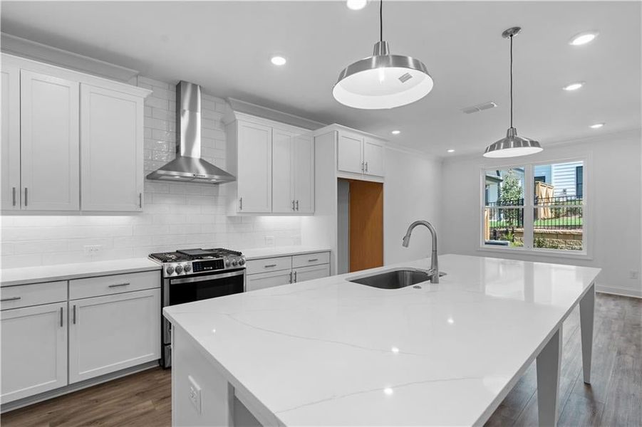 single bowl sink in kitchen- garbage disposal, pendant lighting over island - Pictures represent a previously built home