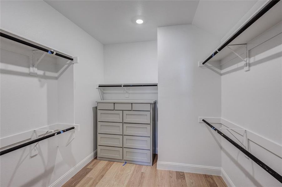 Walk in closet featuring light wood-type flooring