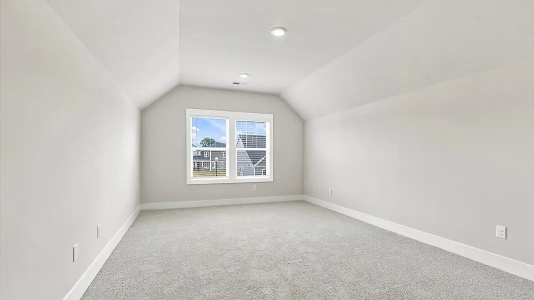 Top-notch design defines this bonus room with carpeted floors and an open, airy layout in Inman, SC