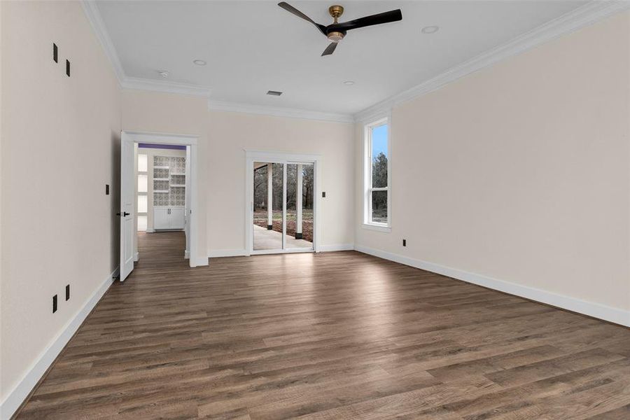 This is a view of the Primary bedroom from the sitting area showcasing the slider going out onto your patio.