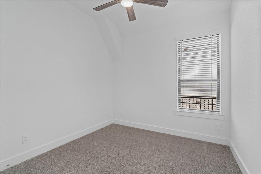 This secondary bedroom features high sloped ceiling, ceiling fan, custom paint, plush carpet, large window with blinds, and an ample sized closet space! This secondary bedroom features high sloped ceiling, ceiling fan, custom paint, plush carpet, large window with blinds, and an ample sized closet space!