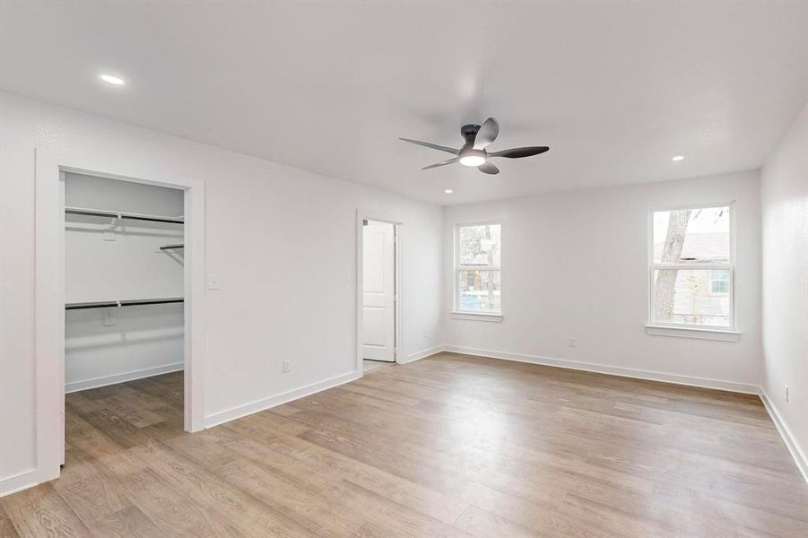 Unfurnished bedroom featuring a closet, ceiling fan, and light hardwood / wood-style flooring