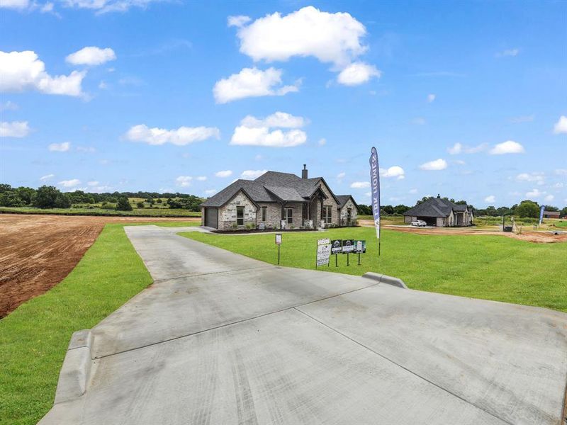 Front exterior of a new home in , Azle, TX, highlighting curb appeal (Image 22). Front exterior of a new home in , Azle, TX, highlighting curb appeal (Image 22).