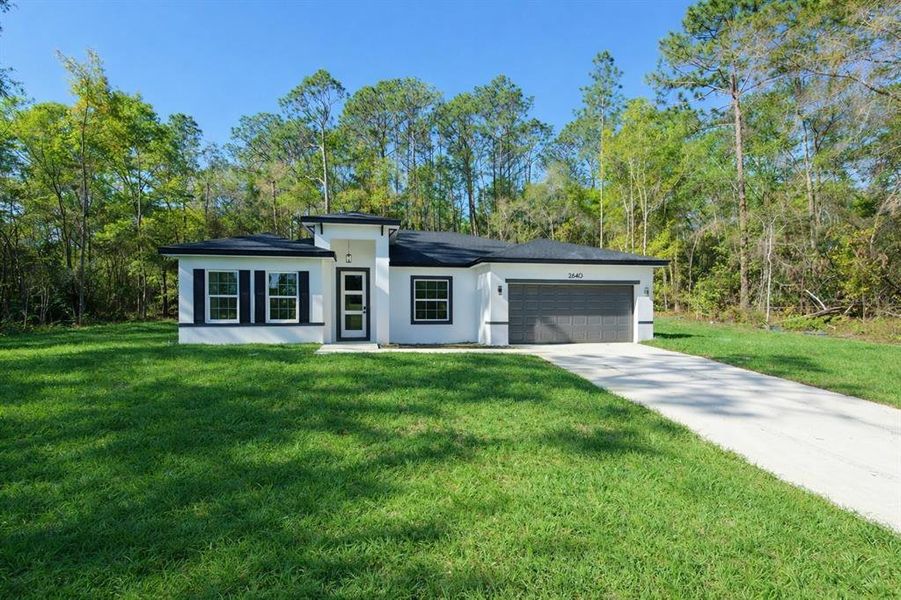 Front exterior of a new home in , Citrus Springs, FL, highlighting curb appeal (Image 19). Front exterior of a new home in , Citrus Springs, FL, highlighting curb appeal (Image 19).
