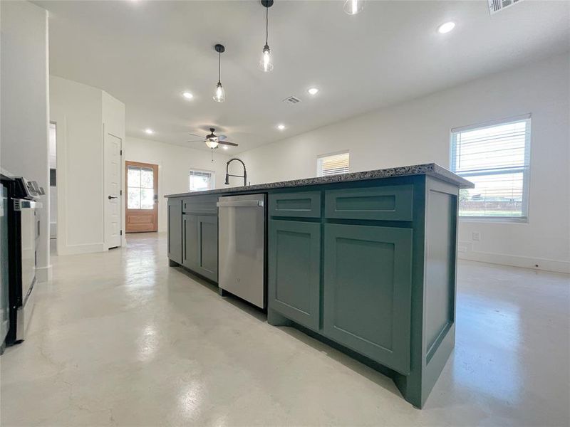 Kitchen with green cabinetry, sink, stainless steel dishwasher, ceiling fan, and pendant lighting