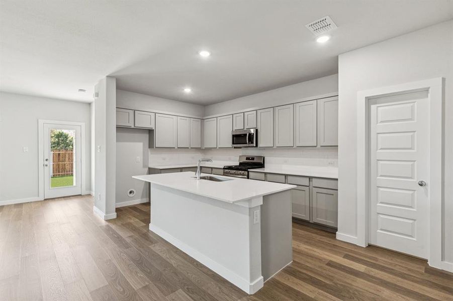 Kitchen in the Oscar home plan by Trophy Signature Homes – REPRESENTATIVE PHOTO