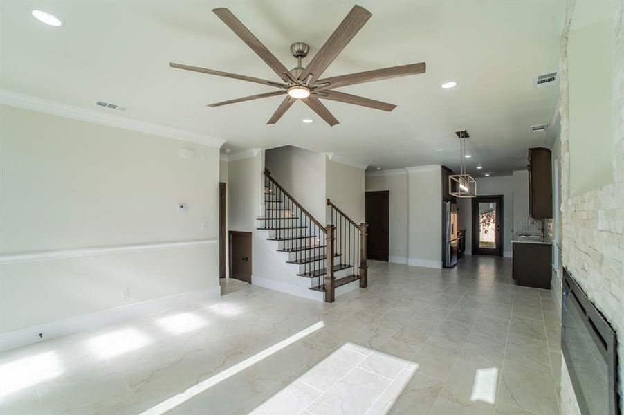 Stairway with recessed lighting, ceiling fan, crown molding, and marble finish floors Stairway with recessed lighting, ceiling fan, crown molding, and marble finish floors
