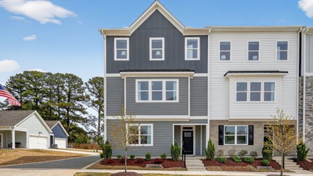 Front exterior of a new home in The Townes at Madden West, Fuquay Varina, NC, highlighting curb appeal (Image 1). Front exterior of a new home in The Townes at Madden West, Fuquay Varina, NC, highlighting curb appeal (Image 1).