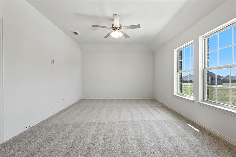 Unfurnished room with vaulted ceiling, ceiling fan, and light carpet Unfurnished room with vaulted ceiling, ceiling fan, and light carpet