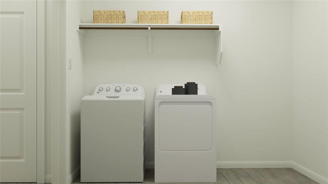 Washroom with separate washer and dryer and light wood-style floors Washroom with separate washer and dryer and light wood-style floors